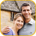Couple standing in front of their house